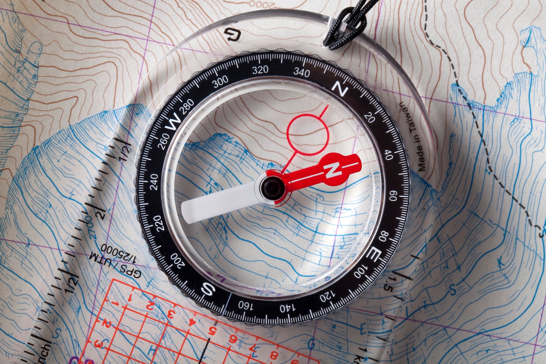 Compass resting on a topographic map